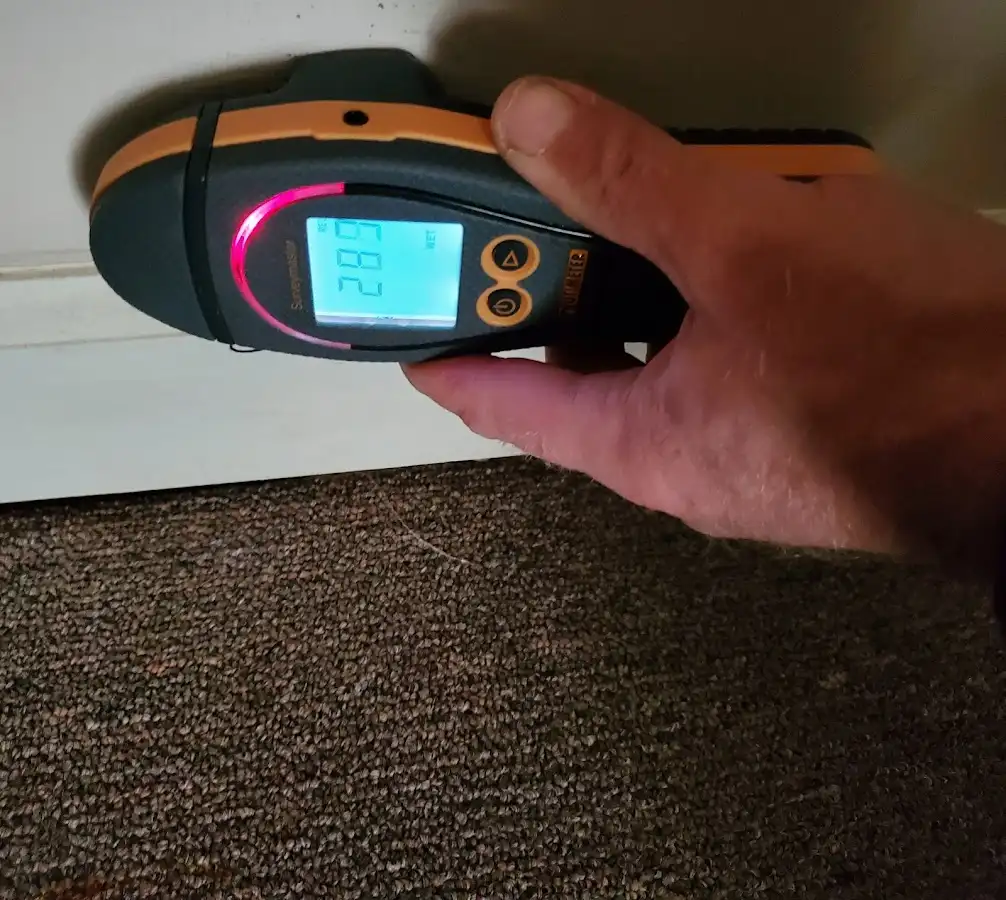 Moisture detection at baseboard during Storm Damage Restoration in Lincoln Village